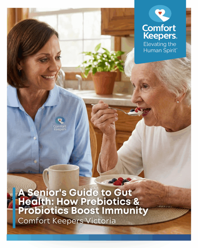 A senior woman eats a bowl of yogurt while seated next to caregiver | A Senior's Guide to Gut Health: How Prebiotics & Probiotics Boost Immunity | Comfort Keepers Victoria