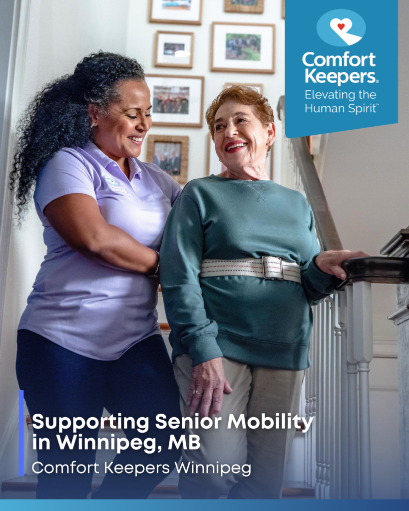 A senior woman is assisted down a flight of stairs by her caregiver | Supporting Senior Mobility in Winnipeg. MB | Comfort Keepers Winnipeg